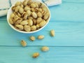 Pistachios on a wooden plate, towel Royalty Free Stock Photo