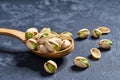 Pistachios in wooden spoon on black table,close-up Royalty Free Stock Photo