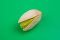 pistacho abierto con el fruto sin piel sobre fondo verde Royalty Free Stock Photo