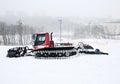 Piste basher on slope at winter resort