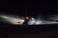 A snow groomer compacting ski runs at night Royalty Free Stock Photo
