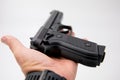 Image of a single gun/pistol in a man`s hand against a isolated white background Royalty Free Stock Photo