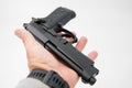 Image of a single gun/pistol in a man`s hand against a isolated white background Royalty Free Stock Photo