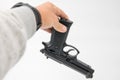 Image of a single gun/pistol in a man`s hand against a isolated white background Royalty Free Stock Photo