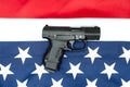 Pistol, american flag flat lay on gray background. United States Gun Laws - Guns and weapons Royalty Free Stock Photo