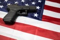 A pistol on the American flag. Gun laws in USA. Handgun, self defense. Royalty Free Stock Photo