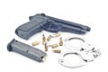 Pistol bullet magazine and handcuff . Royalty Free Stock Photo
