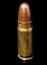 Pistol bullet. Metal case. Old ammunition. Cartridge on a black background. Macro shot of a bullet.