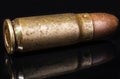 Pistol bullet. Metal case. Old ammunition. Cartridge on a black background. Macro shot of a bullet. Royalty Free Stock Photo