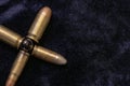 Pistol bullets gathered together in the shape of a cross. War concept. Dark background shot Royalty Free Stock Photo