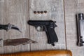 Pistol with a knife on a wooden table Royalty Free Stock Photo