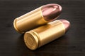 Pistol bullets on the wooden table, 3D rendering