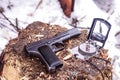 Pistol and compass on the stump. Military composition. Royalty Free Stock Photo