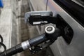 A pistol with diesel fuel in the mouth of a gas tank at a gas station. Royalty Free Stock Photo