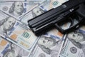 Pistol gun on 100 us dollar banknote,illegal money by gangster dirty job criminal and terrorism concept