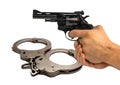pistol in hand on background police handcuffs. concept of justice Royalty Free Stock Photo
