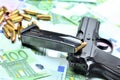 Pistol handgun, loaded magazine and bullets on euro banknotes background Royalty Free Stock Photo