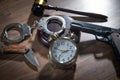 Pistol, knife, handcuffs, judge gavel, alarm clock on the wooden table