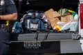 A pistol a magazine and a shotgun sit on the tailgate of a suspects truck during a search of a vehicle by the City of Ventura Po