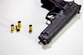 Handgun with 9mm shell casings on white table Royalty Free Stock Photo