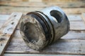 Piston of engine on wooden background, Auto parts industry and spare parts background, piston damage in hard works