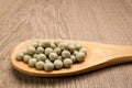 Pea. Grains in wooden spoon. Rustic. Royalty Free Stock Photo