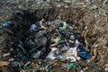 Pit at the garbage dump full of smoke, litter, plastic bottles,rubbish and trash at tropical island Royalty Free Stock Photo