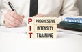 PIT, Progressive Intensity Training symbol. Concept words TSA, tax sheltered annuary on wooden blocks. Beautiful white background