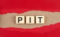 PIT word on wooden cubes on red torn paper , financial concept background Royalty Free Stock Photo