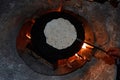 Pita bread baking on a saj or tava on fire, close-up. Royalty Free Stock Photo
