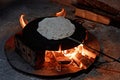 Pita bread baking on a saj or tava on fire, close-up. Royalty Free Stock Photo