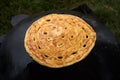 Pita bread baking on a saj or tava on fire, close-up. Traditional arabic pita bread Royalty Free Stock Photo