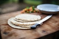 pita bread on a board with a serrated knife Royalty Free Stock Photo