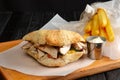 Pita bread with meat, vegetables and fried potato in metal basket and sauce Royalty Free Stock Photo