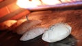 Pita bread in oven. Pita or pide bread covered with egg and sesame on on wooden oar in oven or stove. Bakery or bakehouse concept