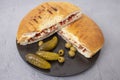 Pita bread sandwich with pickles and olives on gray cement Royalty Free Stock Photo