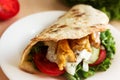 Pita with chicken, vegetables and sauce, delicious lunch, fast. Royalty Free Stock Photo