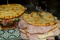 Pita with ham, cheese and salami display at the market. Italian street food Royalty Free Stock Photo