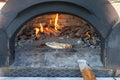 Pita, pizza is cooking in a wood fire in a stone oven Royalty Free Stock Photo