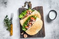 Pita sandwich with roasted chicken, vegetables and delicious sauce. White background. Top view Royalty Free Stock Photo