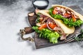 Pita sandwich with roasted chicken, vegetables and delicious sauce. White background. Top view. Copy space Royalty Free Stock Photo