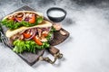 Pita sandwich with roasted chicken, vegetables and delicious sauce. White background. Top view. Copy space Royalty Free Stock Photo