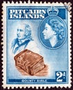 PITCAIRN ISLANDS - CIRCA 1957: A stamp printed in Pitcairn Islands shows John Adams, Bounty Bible and Queen Elizabeth II, circa 19 Royalty Free Stock Photo