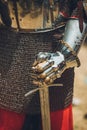 Pitch battle of medieval knights, using metal armor, axes, swords and shields to defend themselves Royalty Free Stock Photo