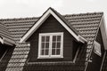 pitched roof dormer loft with white window and concrete tiles