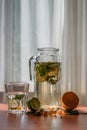 Pitcher and glass of homemade lemonade with scattered ingredients Royalty Free Stock Photo