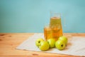 Pitcher and glasses of apple juice and fresh apples near on table. Selective focus Royalty Free Stock Photo