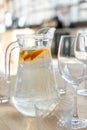 Pitcher of homemade lemonade drink of soda water, lemon, orange and fresh mint leaves on wooden table with glasses Royalty Free Stock Photo