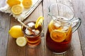 Pitcher of iced tea with filled glass on rustic wood