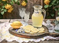 Pitcher of lemonade with fresh lemons on a wooden board Royalty Free Stock Photo